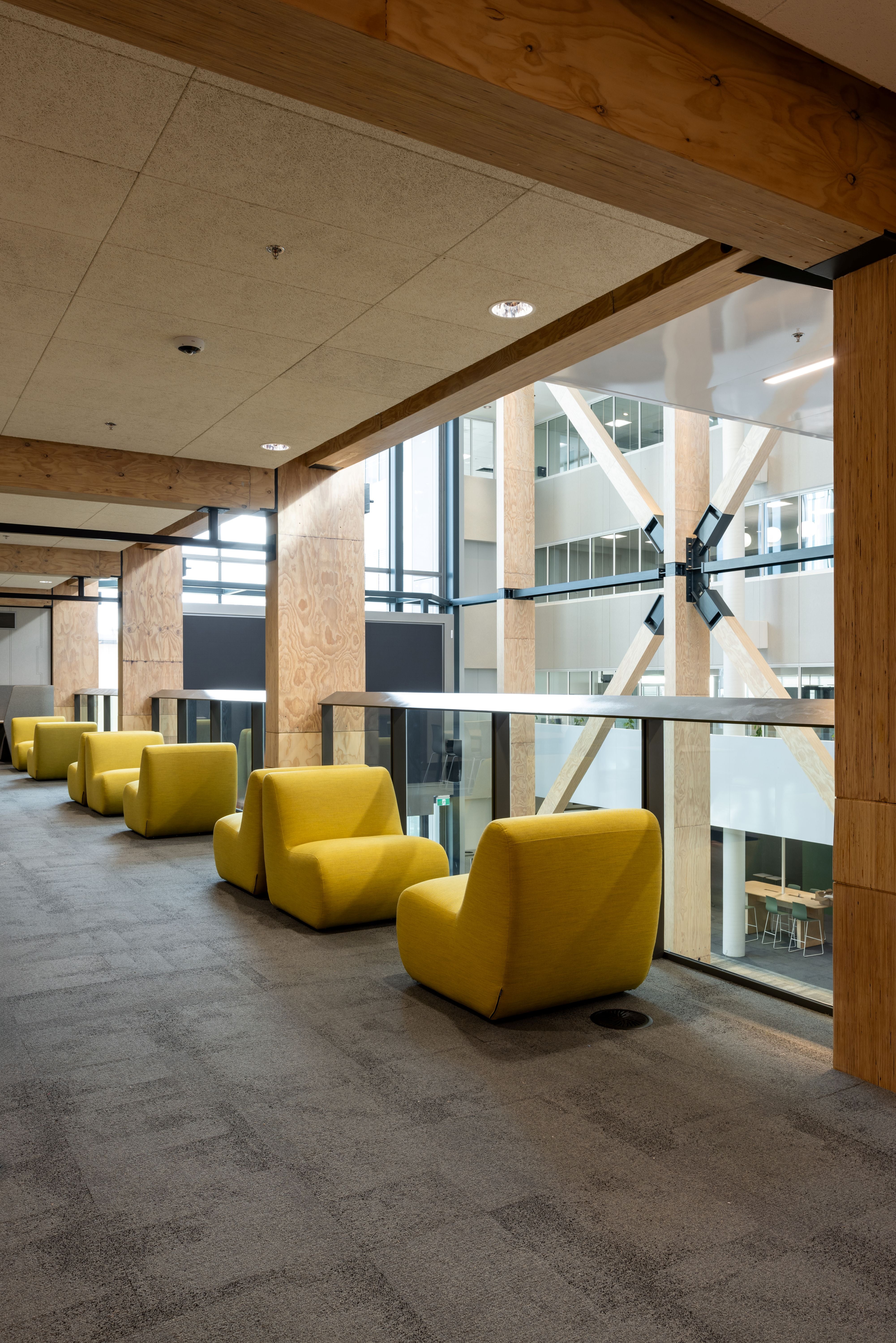 Modern interior with yellow chairs and large windows