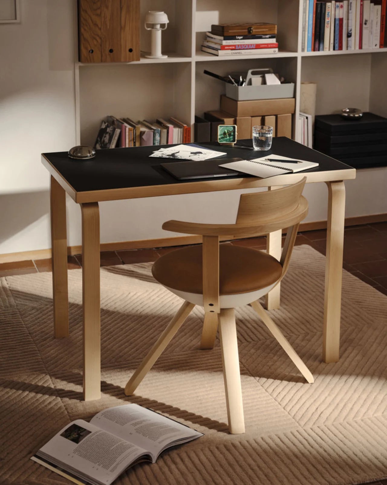 Dining table with chairs in a room with shelves and books