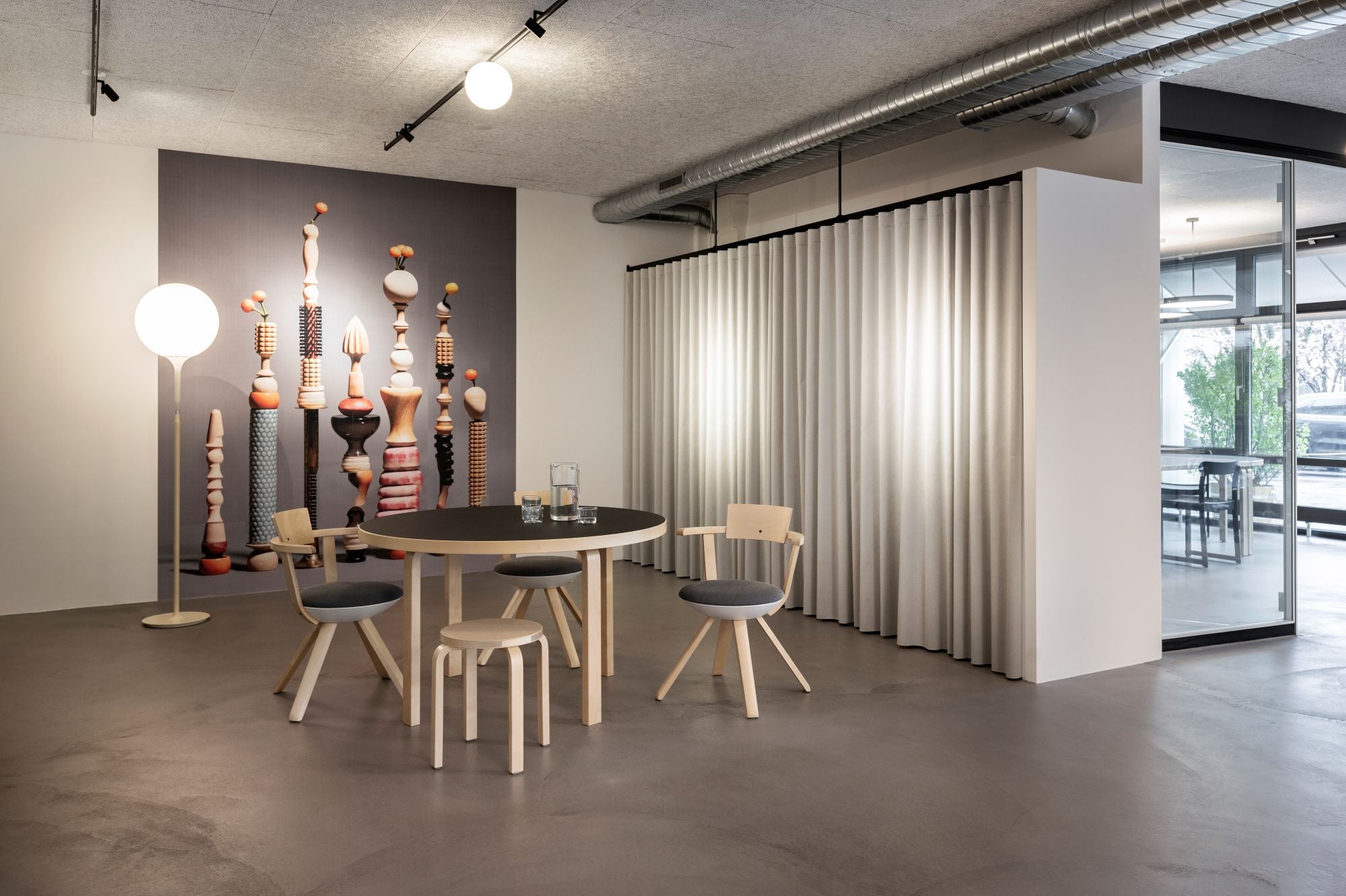 Modern dining area with a round table and chairs in a stylish interior setting.
