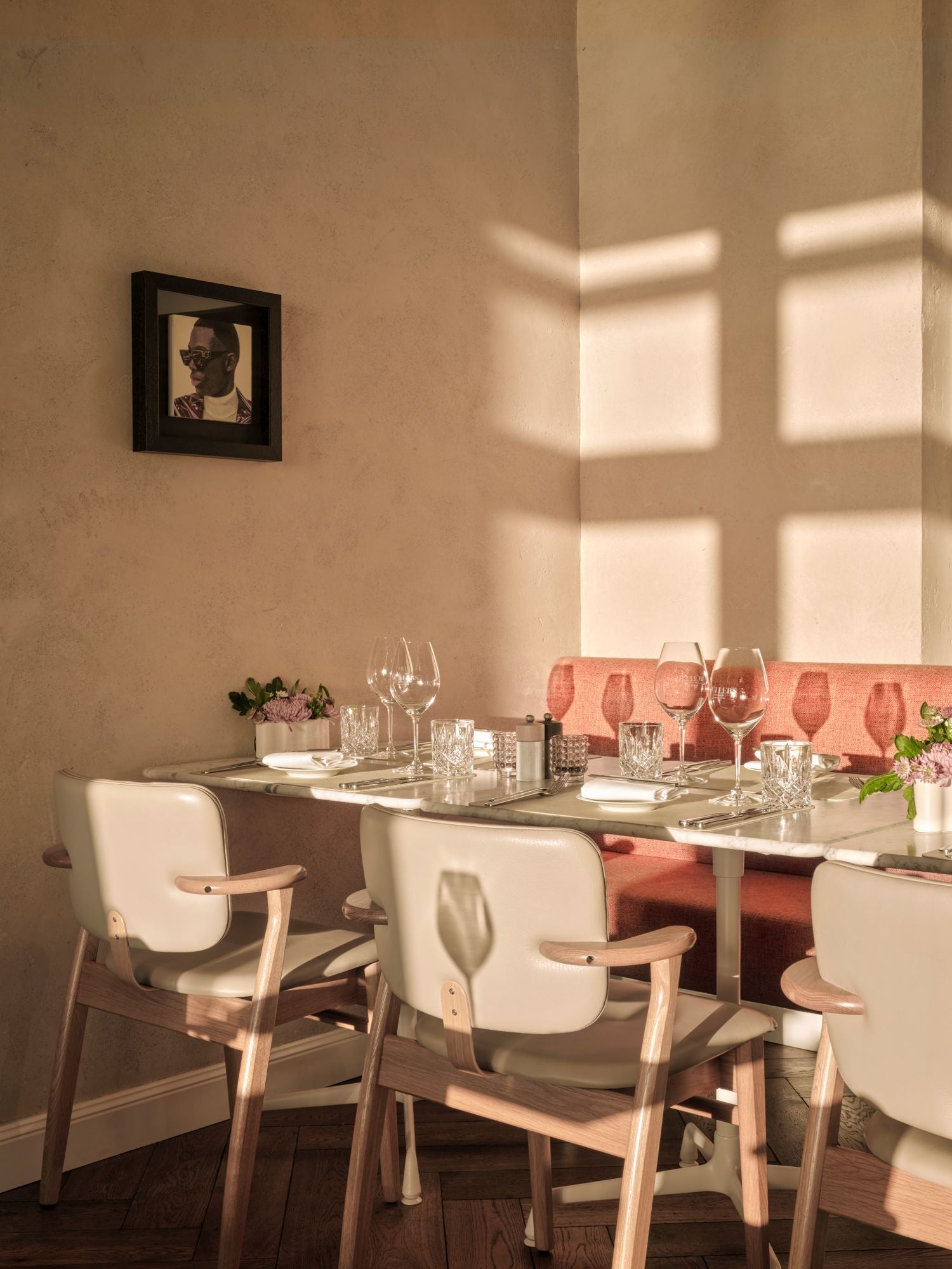 Dining area with a table set for four, chairs, and decorative elements.