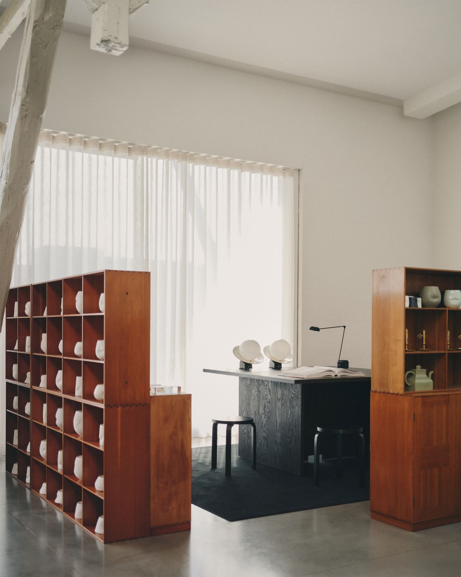 Modern office space with wooden bookshelves and a desk.