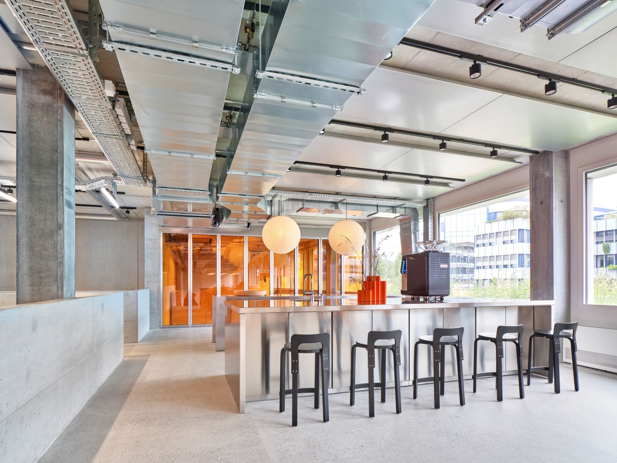 Modern office space with a kitchen island and stools