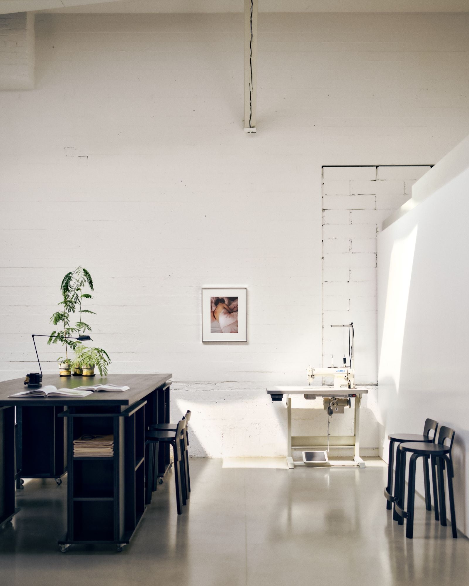 Modern office space with a desk, chairs, and decor elements.