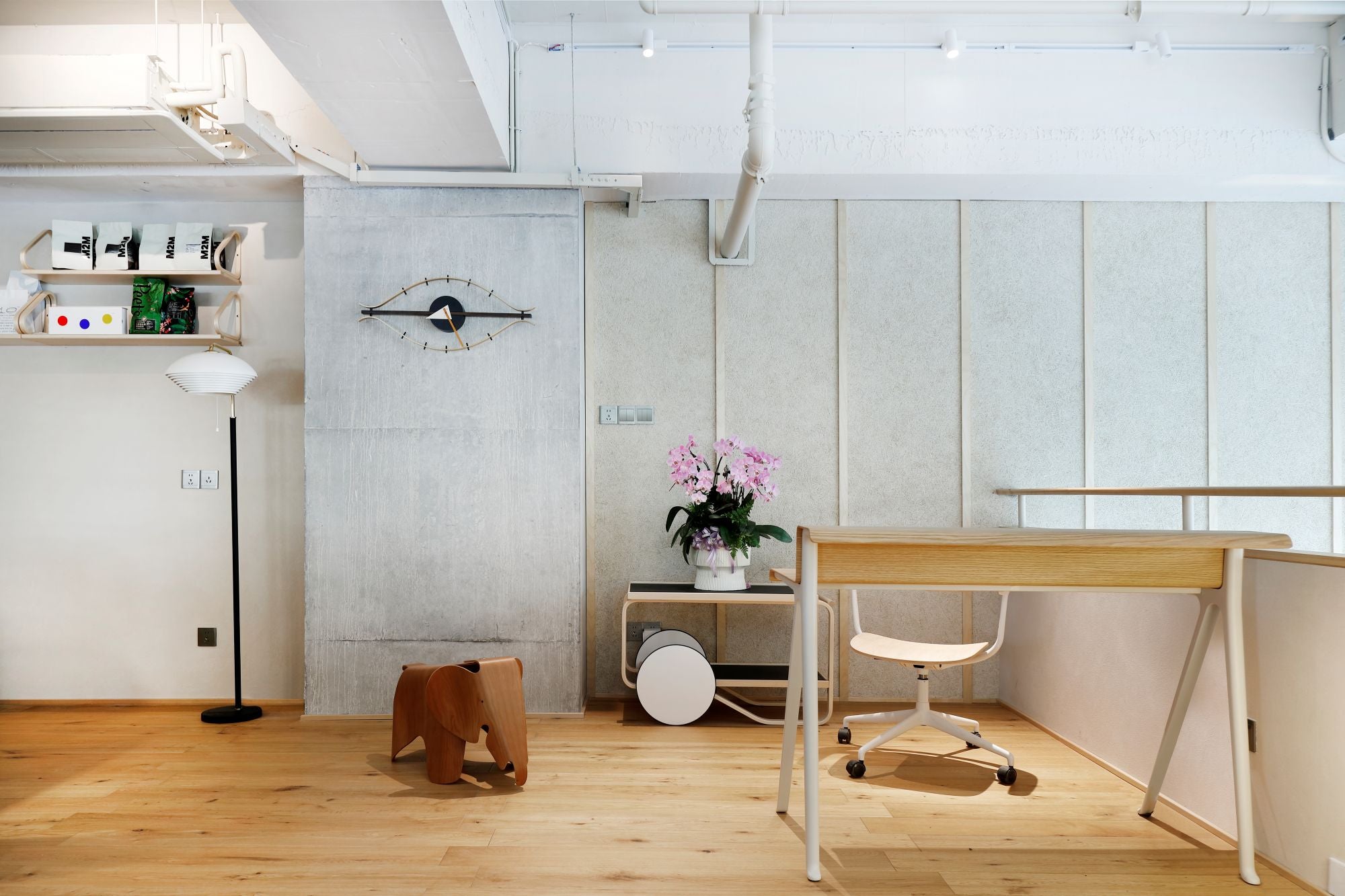 Modern office space with a desk, chair, and decorative elements.