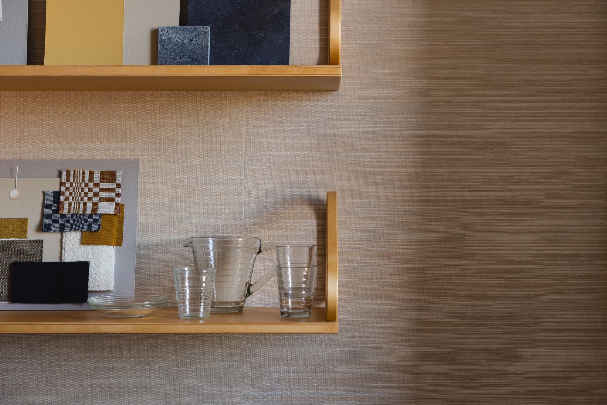 Wooden shelf with decorative items against a textured wall