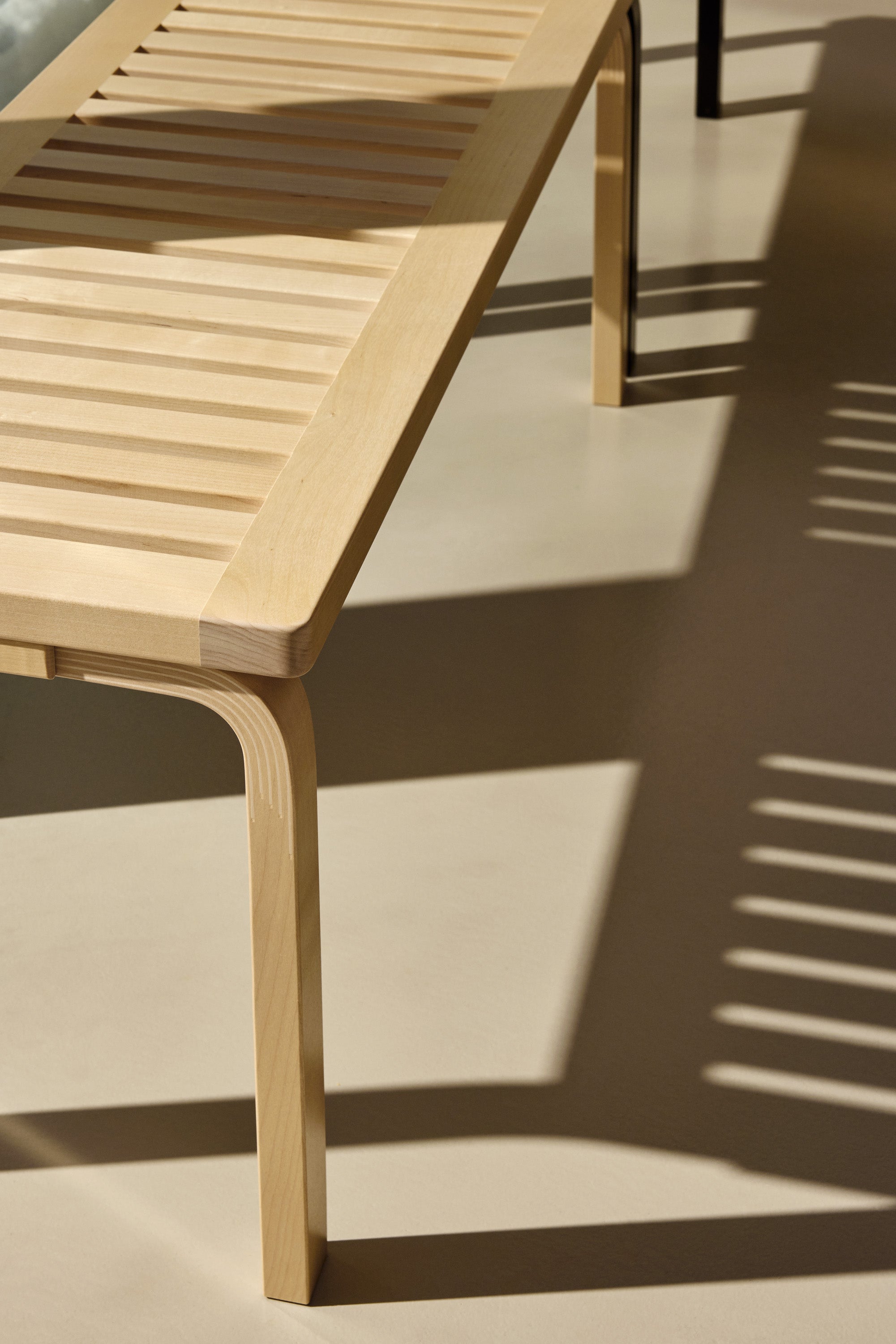 Wooden chair with slatted design on a light background