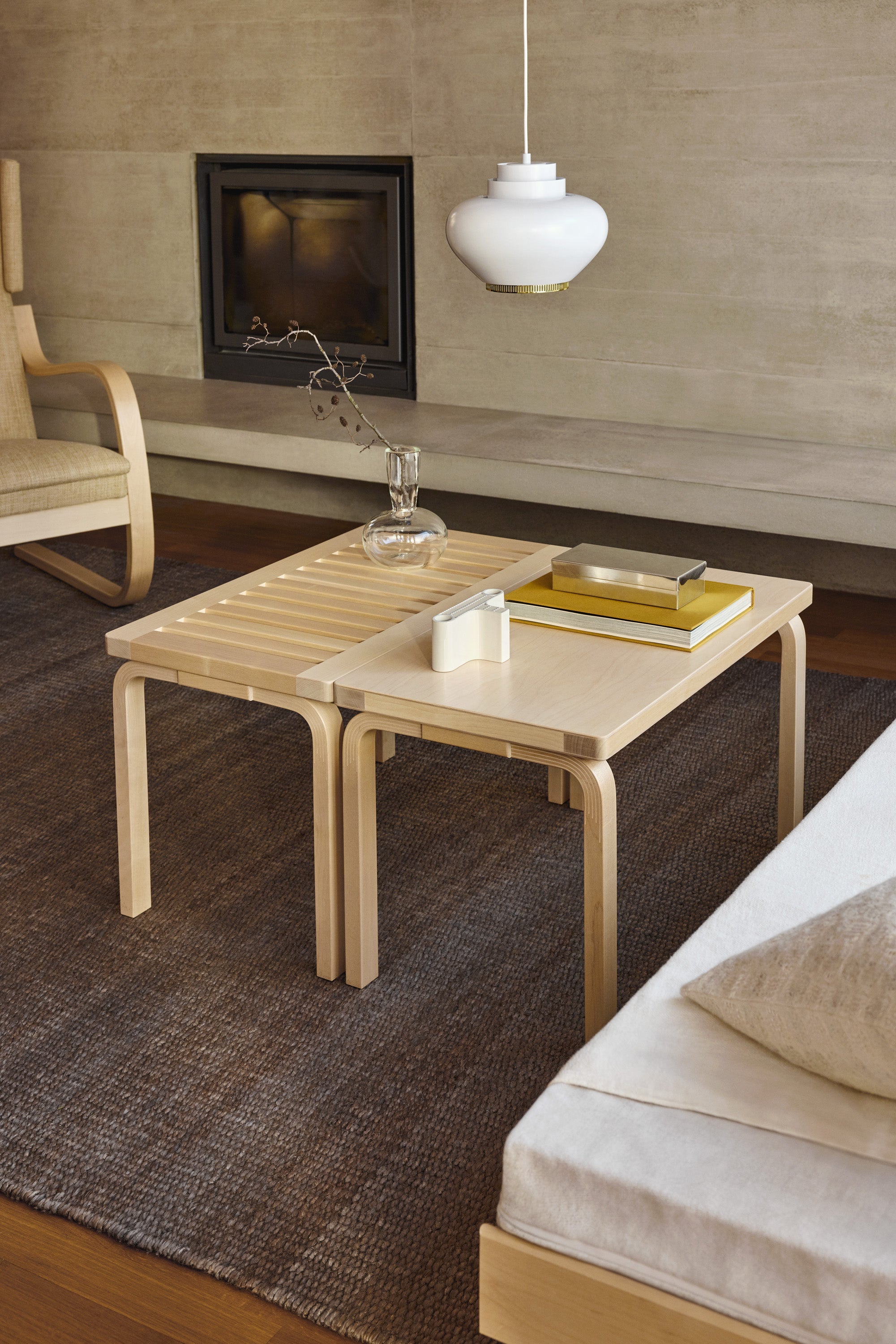 Modern living room with a wooden coffee table, sofa, and fireplace.