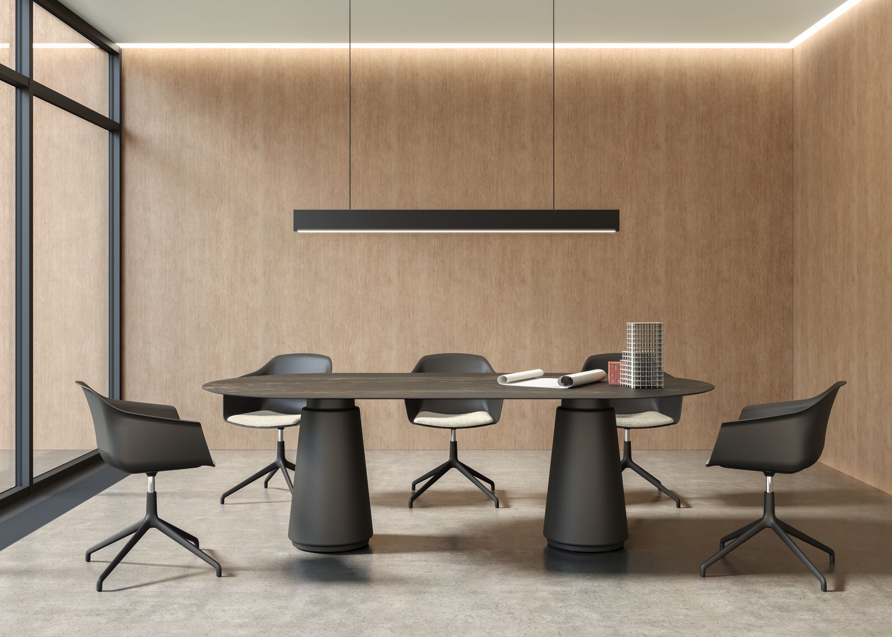 Modern conference room with a round table and chairs in a well-lit office setting.