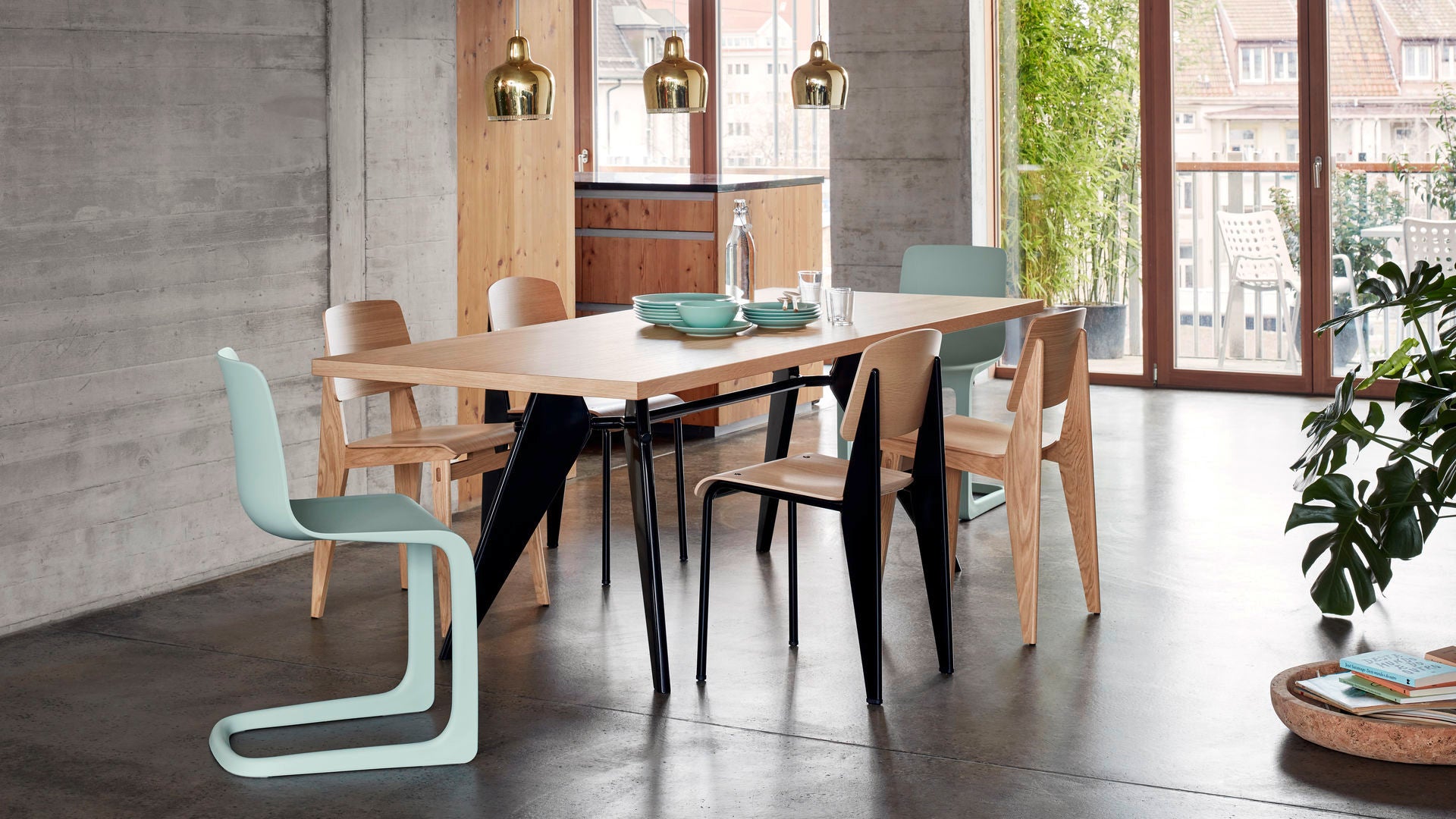 Modern dining room with a wooden table and chairs in a well-lit room.