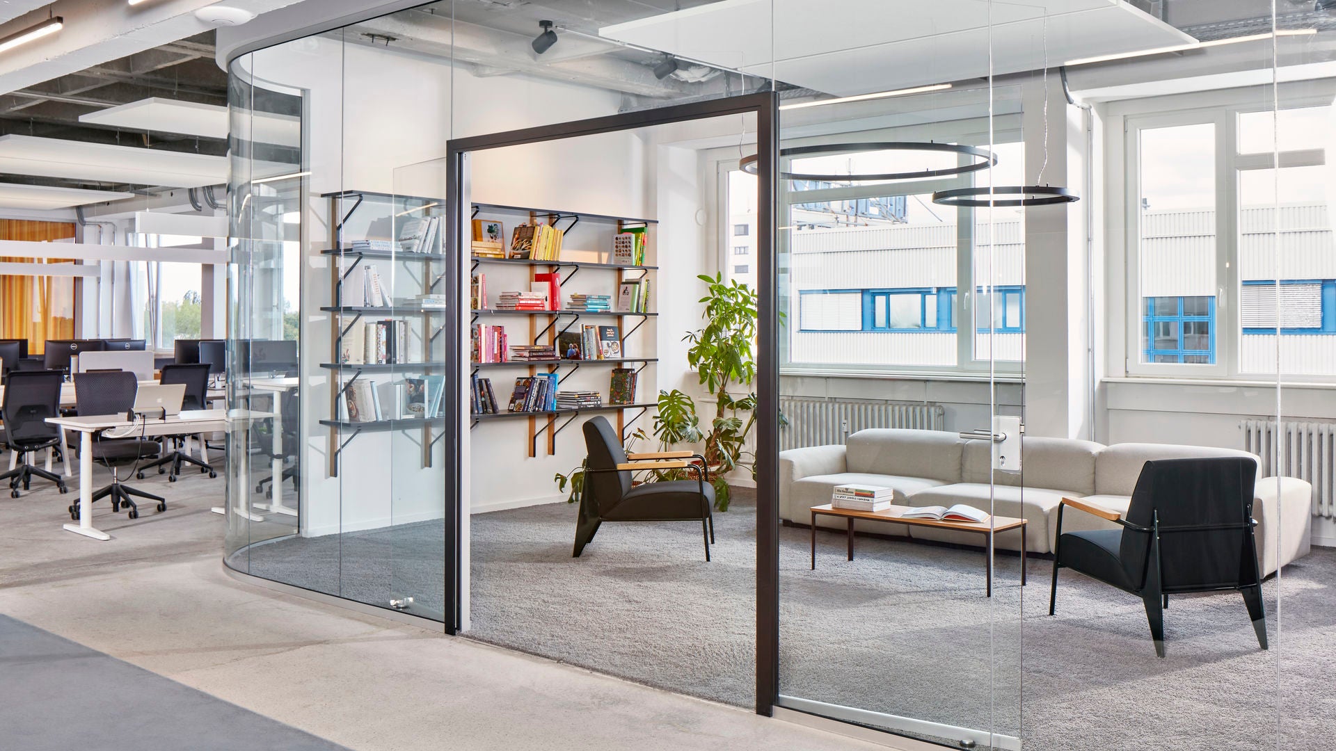 Modern office space with glass partitions and office furniture.