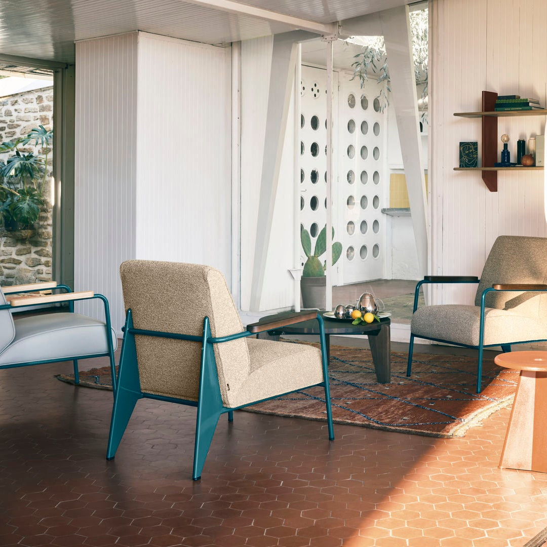 Modern living room with furniture and sliding glass doors leading to an outdoor area.