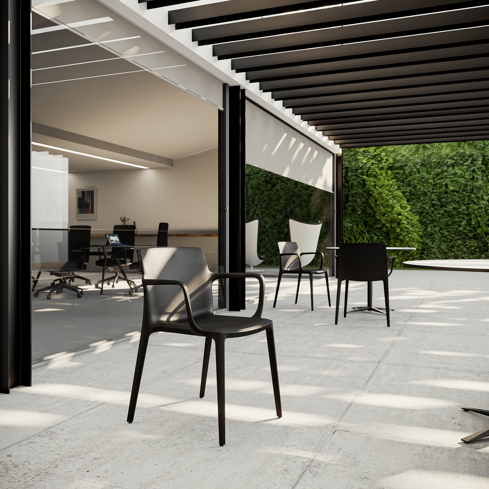 Modern outdoor seating area with chairs and tables under a pergola.