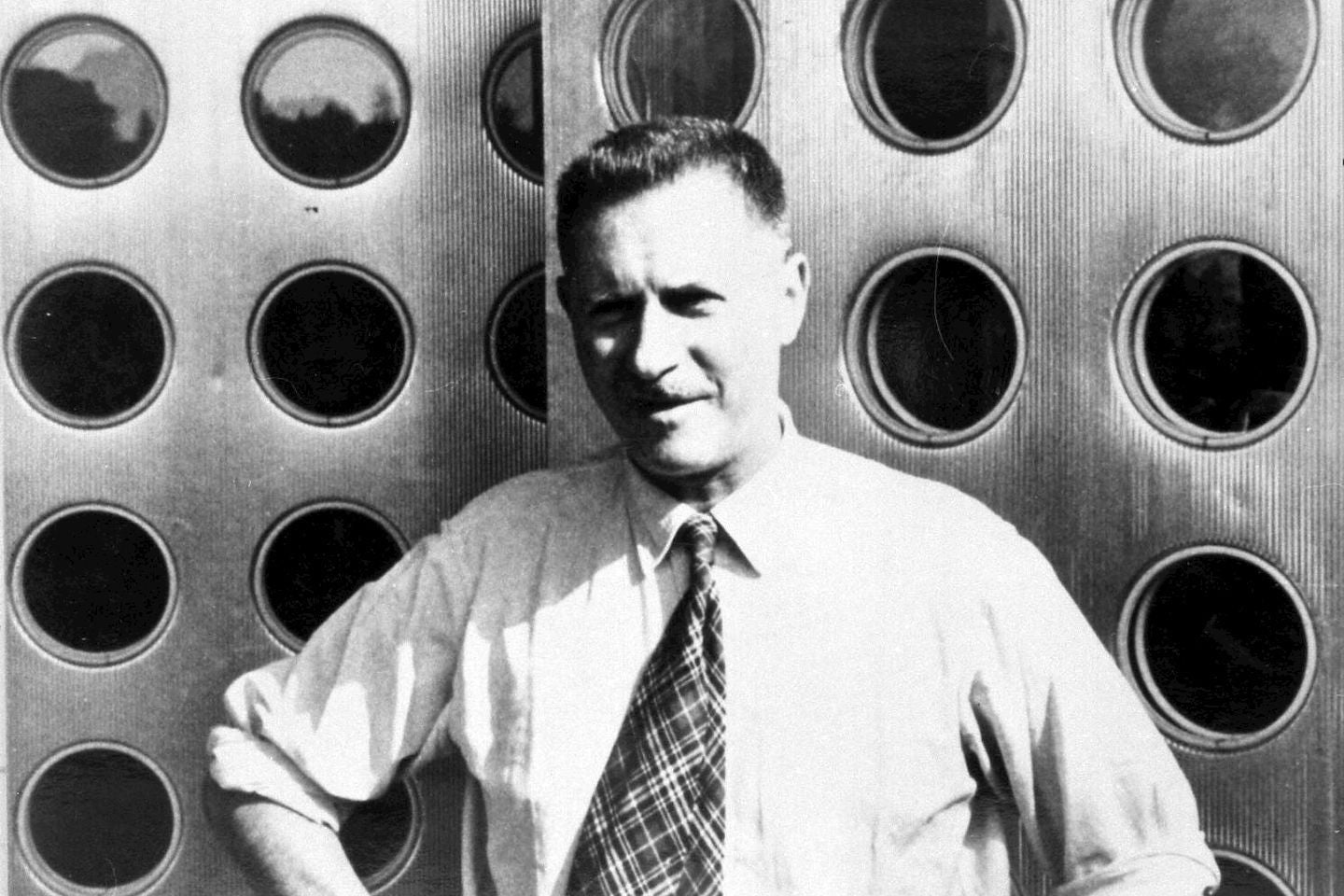 Man standing in front of a metallic background with circular patterns