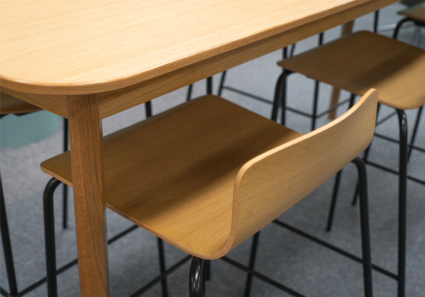 Wooden bar stool with a curved design in a casual setting