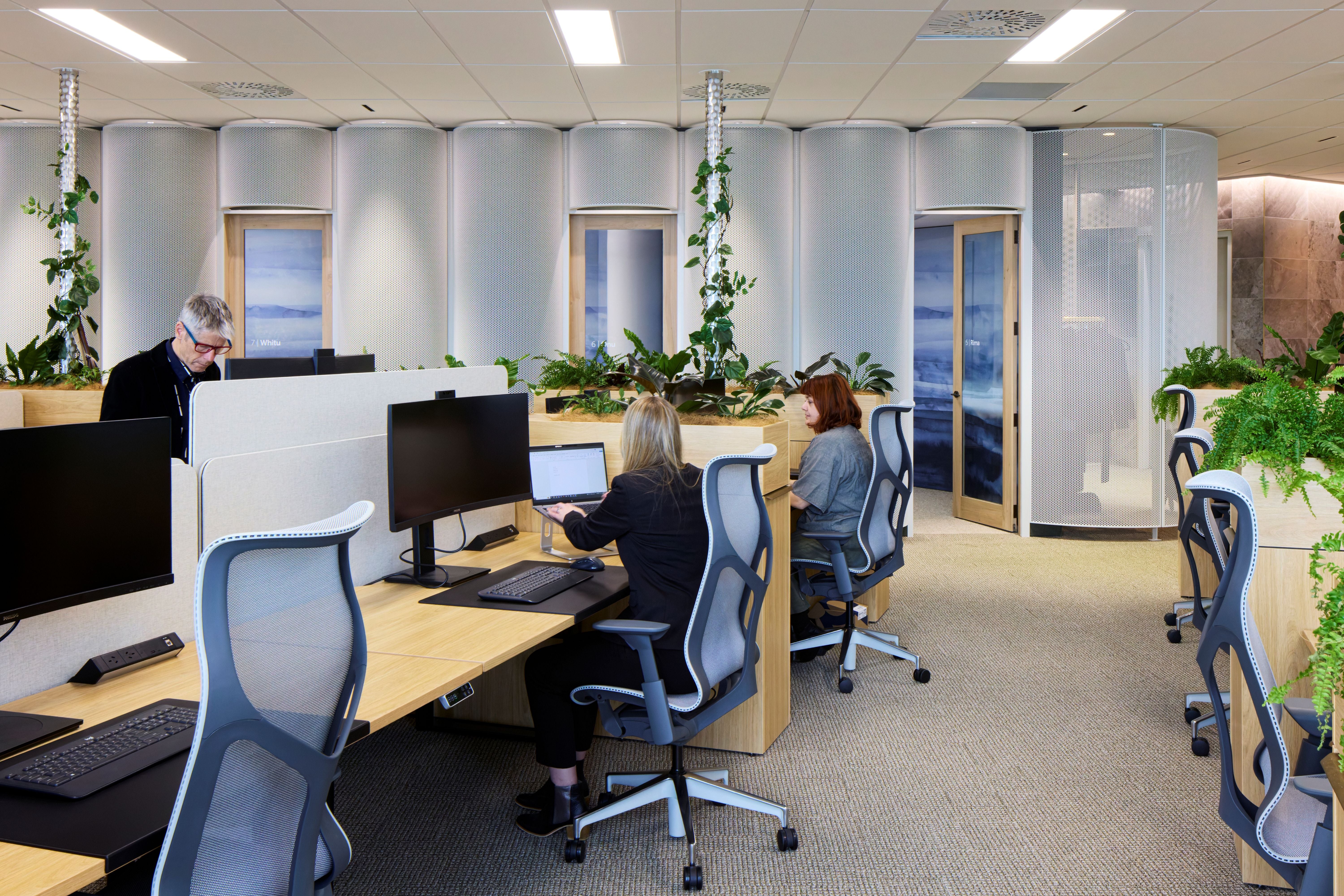 Modern office with employees working at their desks.