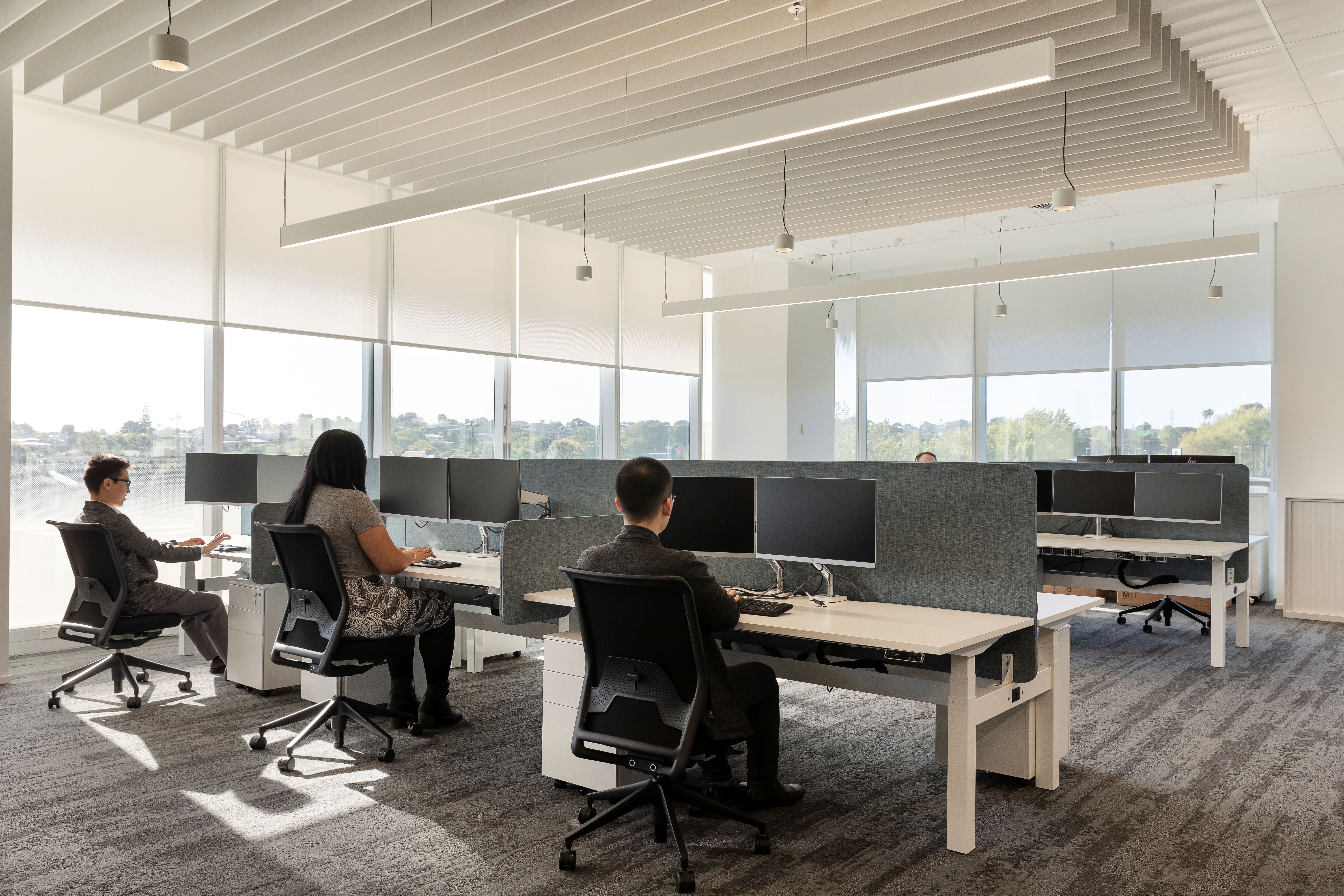 Modern office space with employees working at their desks.