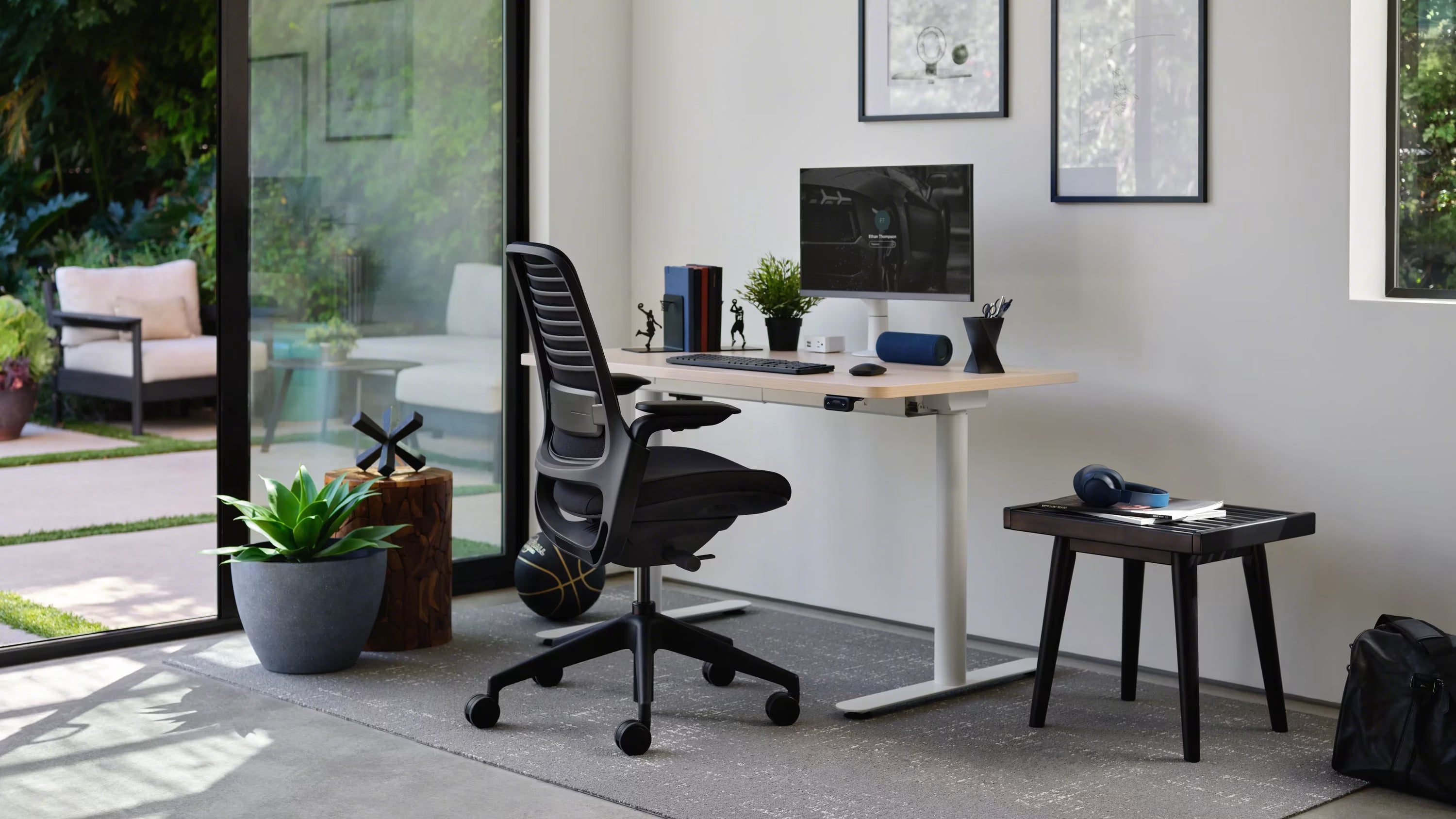 Modern home office with a desk, chair, and computer setup.